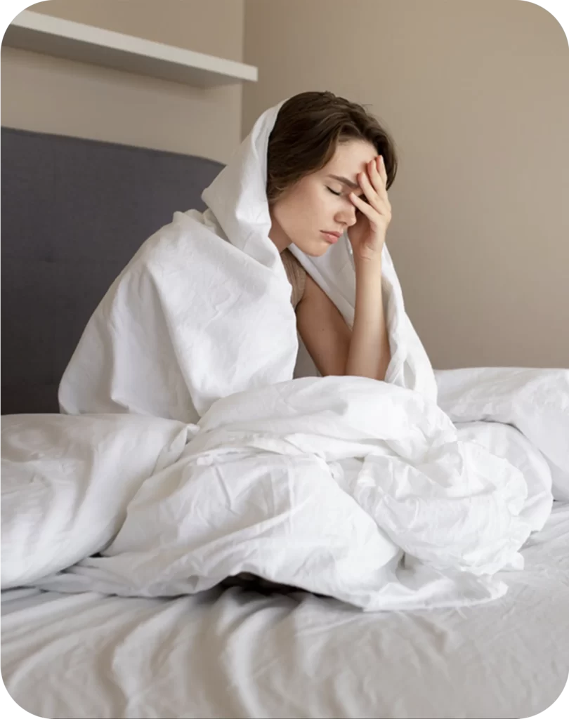 Woman in bed suffering from headache